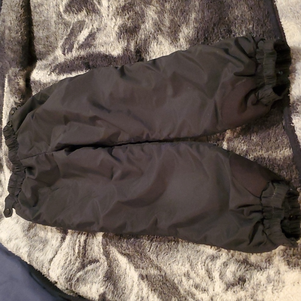 Columbia kids pull on snow pants with adjustable sides.  This is black and 10/12